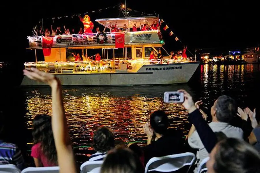 The club's lit-up boat in the Naples Christmas boat parade at night