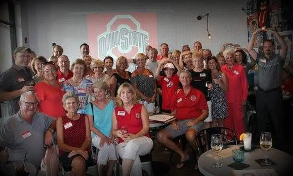 A club gathering in front of the Ohio State banner