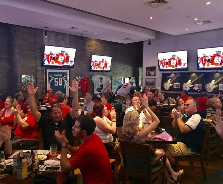 Members at a sports bar with the game on every screen